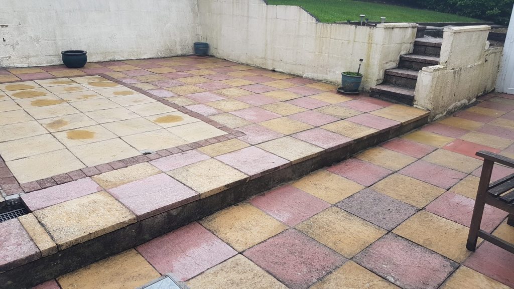 Patio slabs been cleaned after pressure washing.